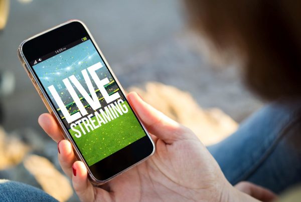 Person holding a Smartphone with text Live Streaming