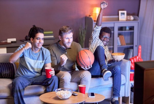 Men at home watching a basketball game