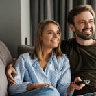 Couple sitting on the couch watching tv