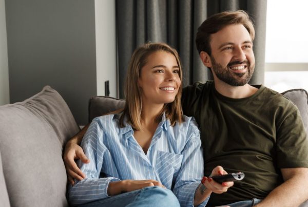 Couple sitting on the couch watching tv