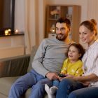 Family on the couch watching tv