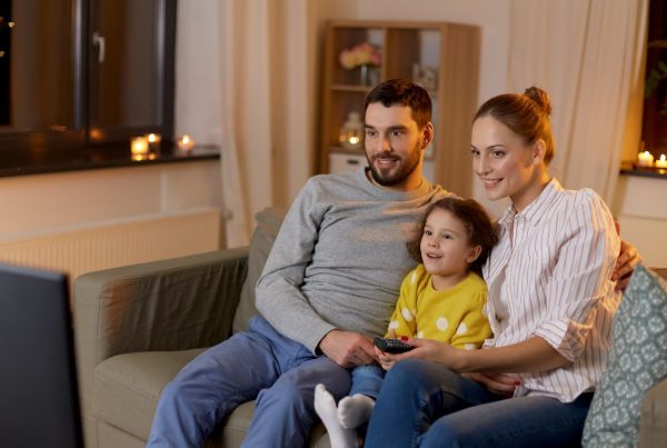 Family on the couch watching tv