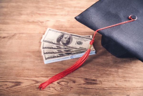 Graduation cap and dollars