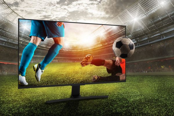 Soccer players on a TV in a soccer field