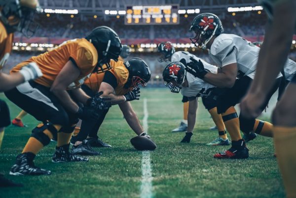 Football players in game on field